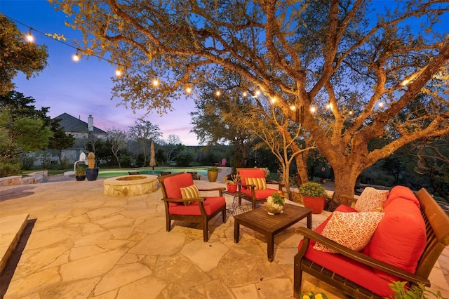 12316 Triple Creek Dr, Dripping Springs, TX 78620 - patio terrace at dusk with a patio area and an outdoor living space with a fire pit