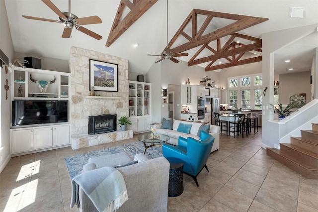 12316 Triple Creek Dr, Dripping Springs, TX 78620 - living area featuring ceiling fan, high vaulted ceiling, a stone fireplace, beam ceiling, and light tile patterned floors