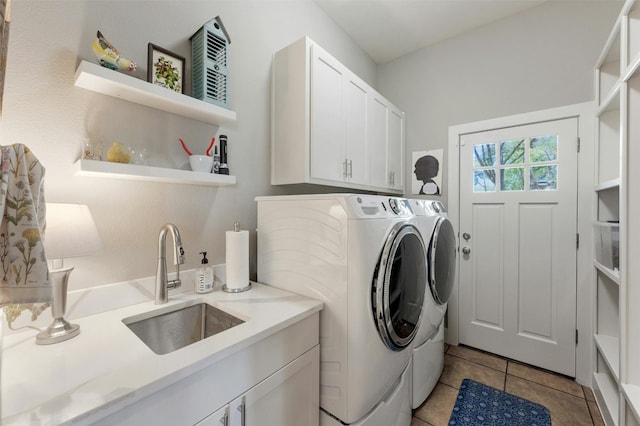 12316 Triple Creek Dr, Dripping Springs, TX 78620 - laundry room featuring washing machine and clothes dryer, cabinet space, and light tile patterned flooring