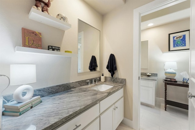 bathroom featuring vanity and baseboards