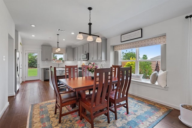 dining room with baseboards, recessed lighting, and dark wood finished floors