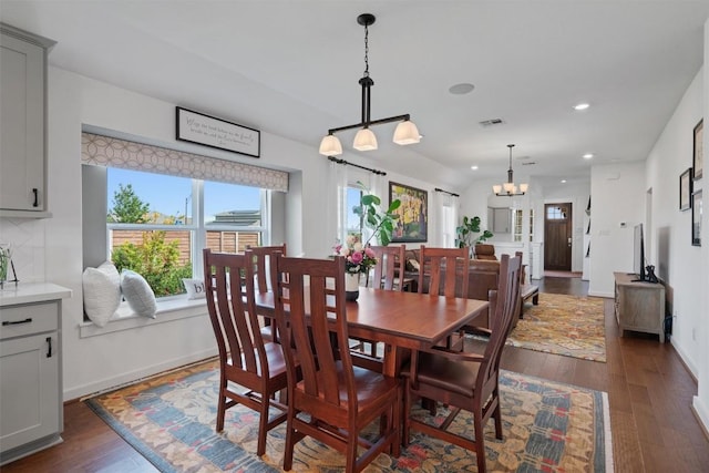 dining space with a chandelier, dark wood-type flooring, recessed lighting, and baseboards