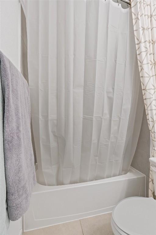 bathroom with shower / bath combination with curtain and toilet