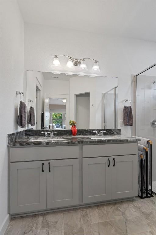 300 Gidran Trl, Georgetown, TX 78626 - bathroom featuring double vanity, a shower with door, and marble finish floors