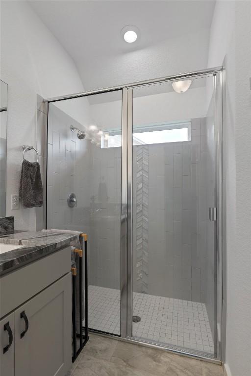 bathroom with vanity and a shower stall