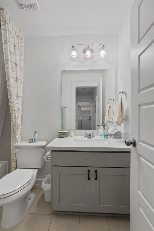 bathroom featuring tile patterned floors, toilet, and vanity