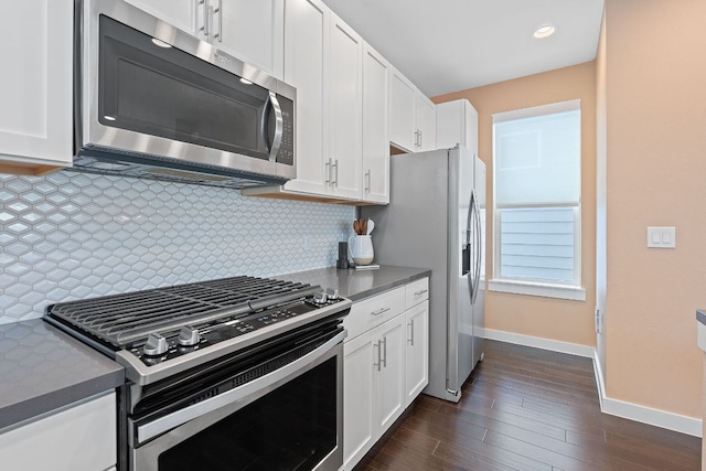 3105 Aldwyche Dr, Austin, TX 78704 - kitchen featuring appliances with stainless steel finishes, baseboards, dark countertops, white cabinetry, and recessed lighting