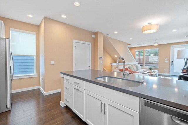 3105 Aldwyche Dr, Austin, TX 78704 - kitchen featuring stainless steel appliances, a sink, dark countertops, open floor plan, and recessed lighting