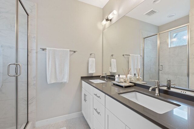3105 Aldwyche Dr, Austin, TX 78704 - bathroom with double vanity, a stall shower, baseboards, and marble finish floors