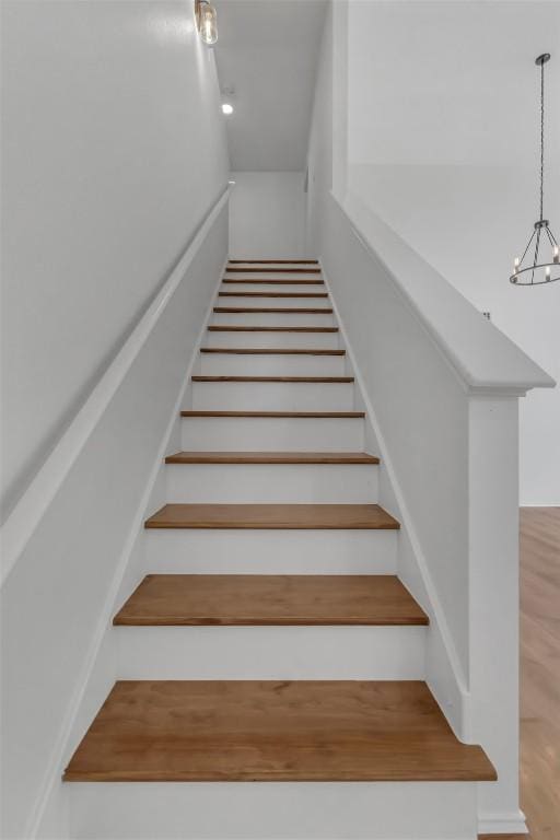 8800 Dandelion Trl, Austin, TX 78745 - stairway with a chandelier