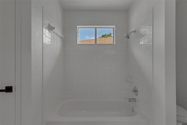 bathroom featuring toilet and bathtub / shower combination