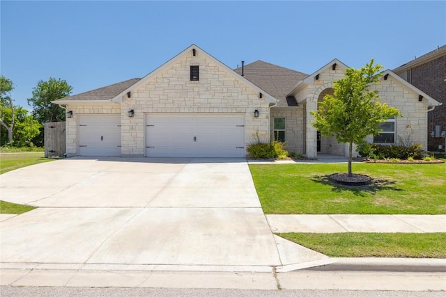 5213 Fresno Ave, Pflugerville, TX 78660 - french provincial home featuring an attached garage, concrete driveway, a front yard, and stone siding
