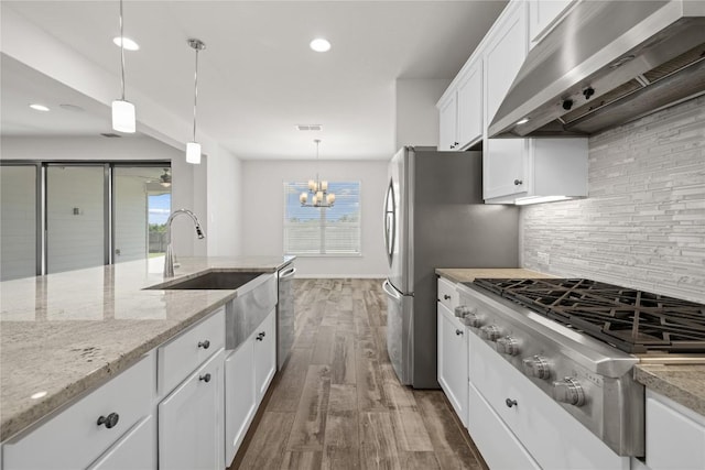 5213 Fresno Ave, Pflugerville, TX 78660 - kitchen featuring extractor fan, appliances with stainless steel finishes, tasteful backsplash, white cabinets, and dark wood finished floors