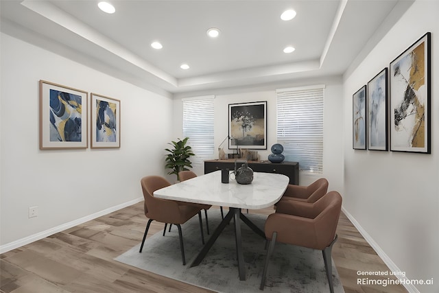 5213 Fresno Ave, Pflugerville, TX 78660 - dining room featuring a tray ceiling, light wood-style flooring, and recessed lighting