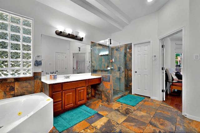 bathroom featuring healthy amount of natural light, a stall shower, vanity, and a jetted tub