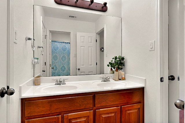 full bathroom featuring double vanity and a shower with shower curtain
