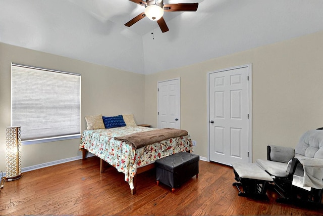 bedroom featuring vaulted ceiling, wood finished floors, baseboards, and ceiling fan