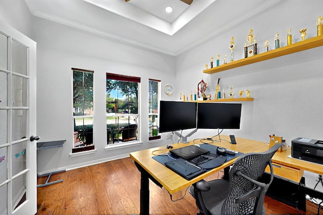 office area featuring hardwood / wood-style floors, crown molding, a raised ceiling, and recessed lighting