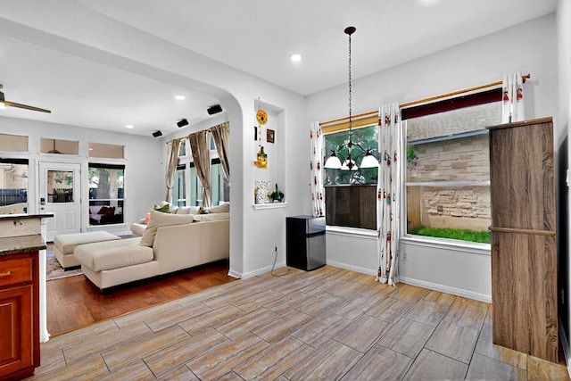 16525 Broadbay Dr, Austin, TX 78717 - living room with wood tiled floors, recessed lighting, baseboards, arched walkways, and ceiling fan