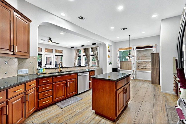 16525 Broadbay Dr, Austin, TX 78717 - kitchen featuring dishwasher, a sink, arched walkways, tasteful backsplash, and recessed lighting