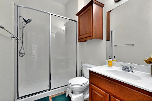 bathroom with a stall shower, toilet, and vanity