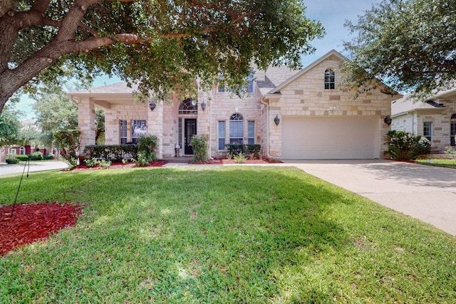 16525 Broadbay Dr, Austin, TX 78717 - view of front facade with stone siding, a front yard, driveway, and a garage