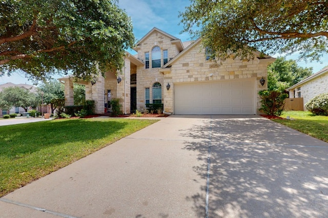 16525 Broadbay Dr, Austin, TX 78717 - traditional-style home with stone siding, a front lawn, driveway, and a garage