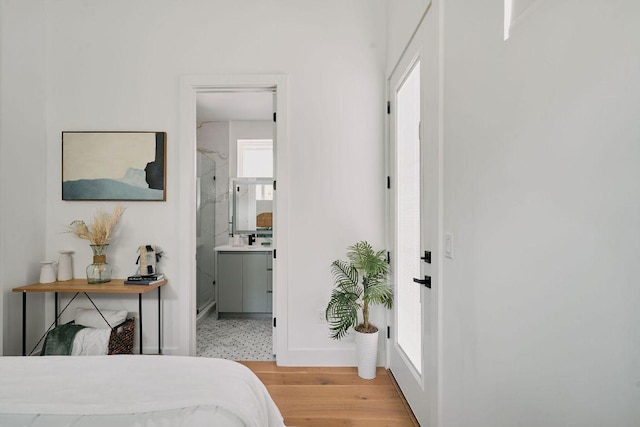 1140 Northwestern Ave Unit 2, Austin, TX 78702 - bedroom with light wood-style flooring and connected bathroom