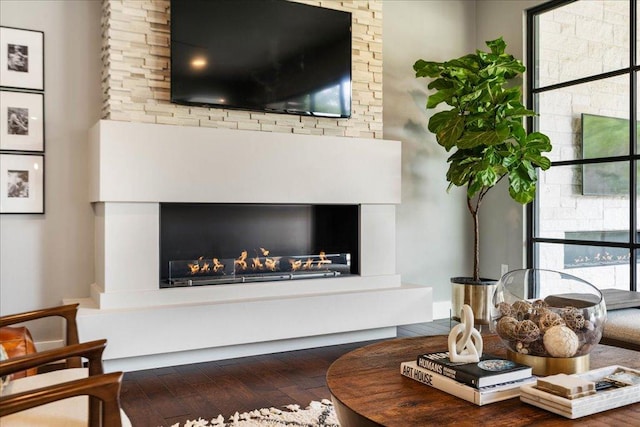 detailed view of a lit fireplace and wood finished floors