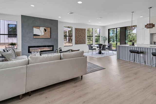 214 Ulupau Cir, Bastrop, TX 78602 - living area with a fireplace, recessed lighting, and light wood-style flooring