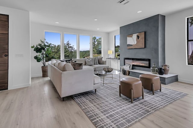 214 Ulupau Cir, Bastrop, TX 78602 - living area featuring light wood-style flooring, recessed lighting, and a large fireplace