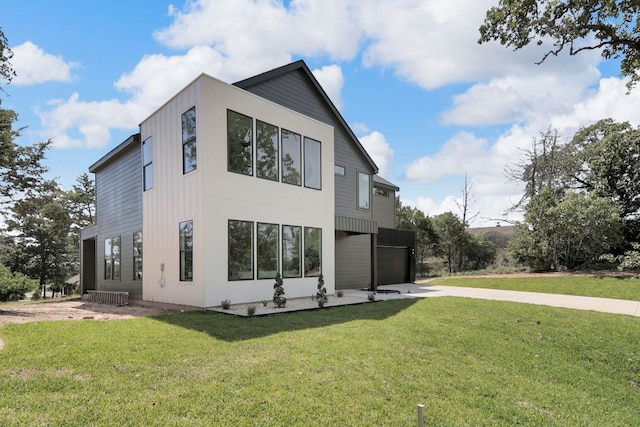 214 Ulupau Cir, Bastrop, TX 78602 - view of property exterior with driveway, a yard, and an attached garage