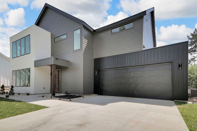 214 Ulupau Cir, Bastrop, TX 78602 - modern home with driveway and a garage