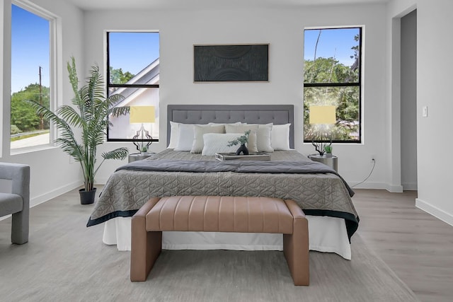 214 Ulupau Cir, Bastrop, TX 78602 - bedroom with multiple windows and wood finished floors