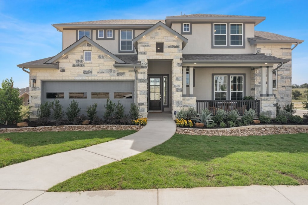 112 Silent Grove Ct, Georgetown, TX 78633 - view of front facade featuring stone siding, stucco siding, and a front lawn