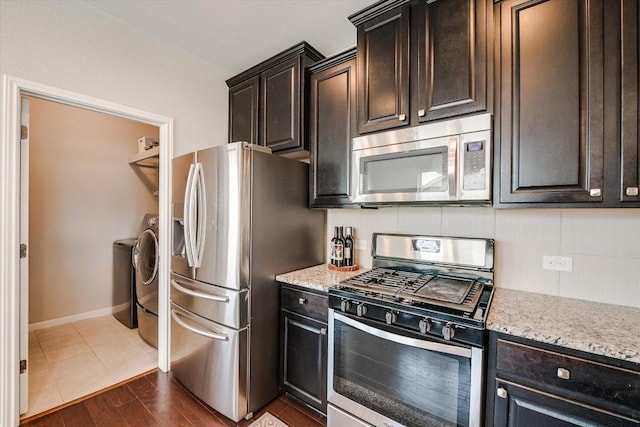 1812 Morts Pl, Manchaca, TX 78652 - kitchen featuring stainless steel appliances, dark brown cabinetry, baseboards, and light stone countertops