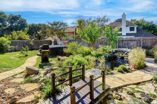 view of yard featuring a garden pond