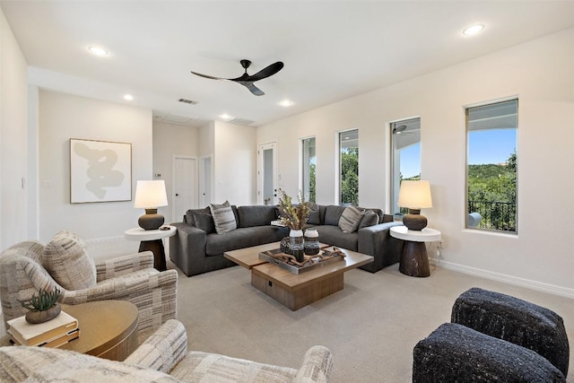 carpeted living room featuring plenty of natural light, a ceiling fan, recessed lighting, and baseboards