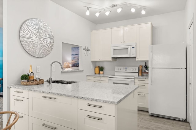4015 Speedway Unit 1, Austin, TX 78751 - kitchen with white appliances, a sink, white cabinetry, light stone counters, and light wood-style floors