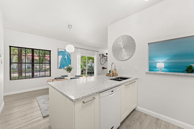 4015 Speedway Unit 1, Austin, TX 78751 - kitchen featuring dishwasher, light wood-style floors, a peninsula, and light stone countertops