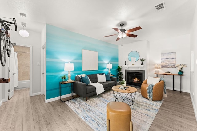 4015 Speedway Unit 1, Austin, TX 78751 - living area featuring wood finished floors, a ceiling fan, baseboards, and a warm lit fireplace