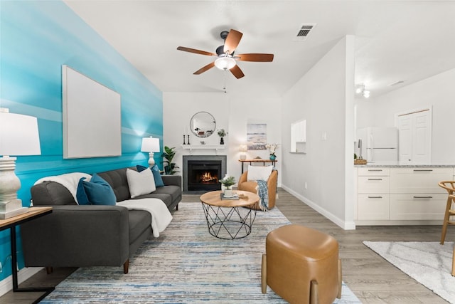 4015 Speedway Unit 1, Austin, TX 78751 - living area with a ceiling fan, light wood finished floors, a lit fireplace, and baseboards