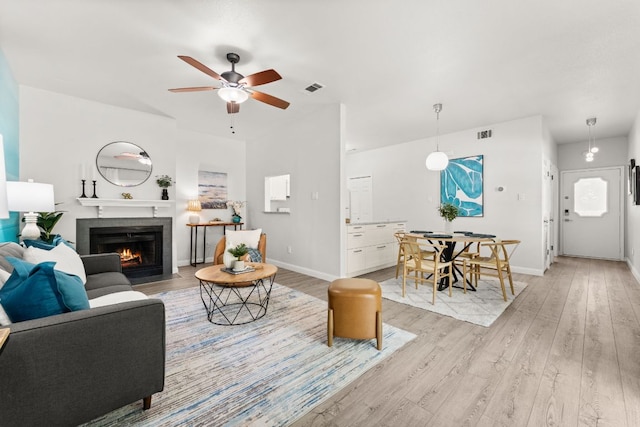 4015 Speedway Unit 1, Austin, TX 78751 - living area with a tile fireplace, light wood finished floors, ceiling fan, and baseboards