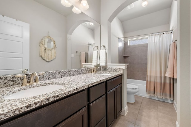 full bathroom with tile patterned floors, double vanity, shower / tub combo with curtain, toilet, and baseboards