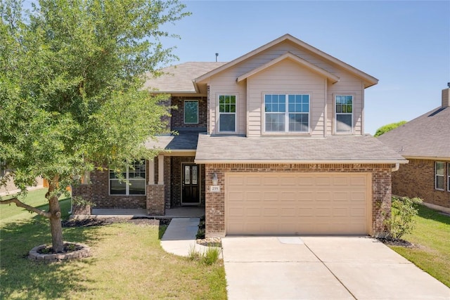 view of front of home featuring brick siding, a front lawn, and concrete driveway