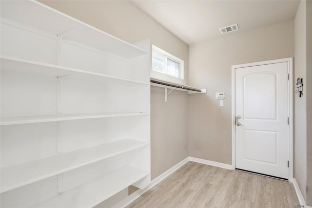 walk in closet featuring wood finished floors