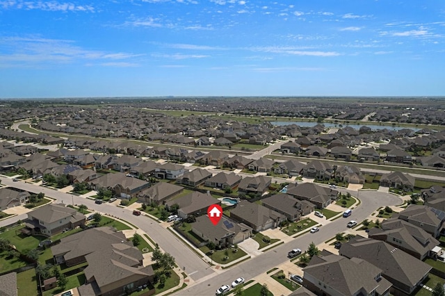 aerial view of property's location featuring a nearby body of water and nearby suburban area