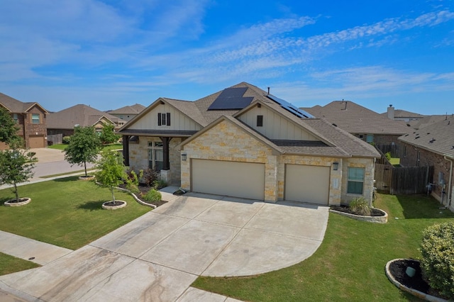 19817 Chayton Cir, Pflugerville, TX 78660 - view of front facade featuring board and batten siding, concrete driveway, stone siding, and solar panels