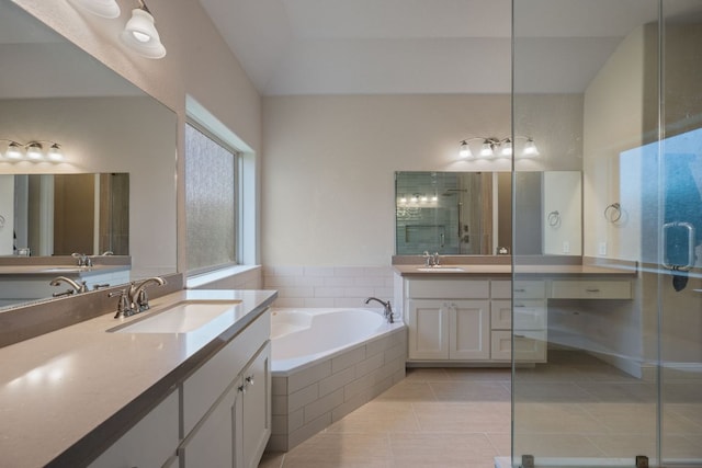 19817 Chayton Cir, Pflugerville, TX 78660 - full bathroom with two vanities, a stall shower, a garden tub, and tile patterned floors