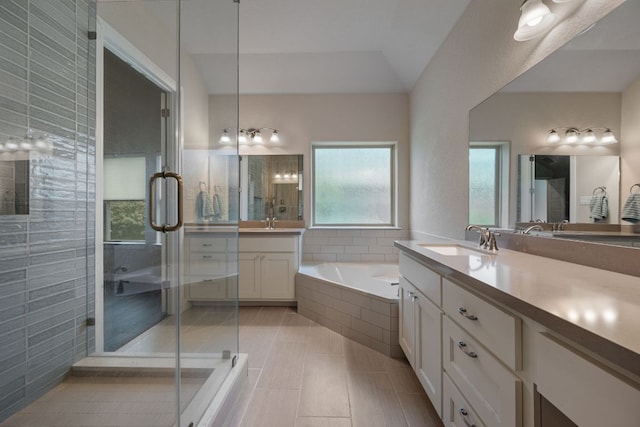 full bathroom with a stall shower, a garden tub, vanity, and tile patterned floors